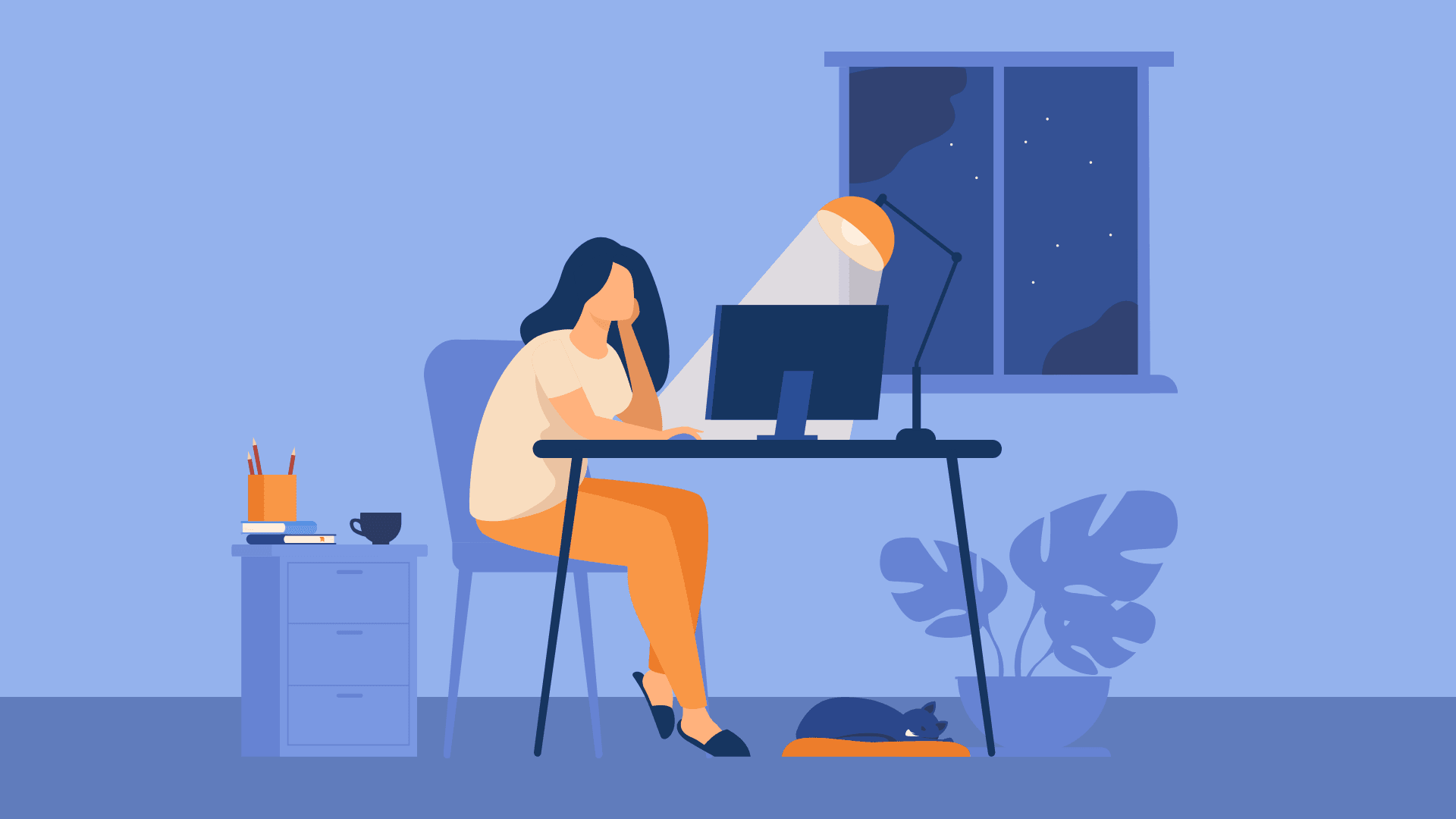 A woman working from home at night.